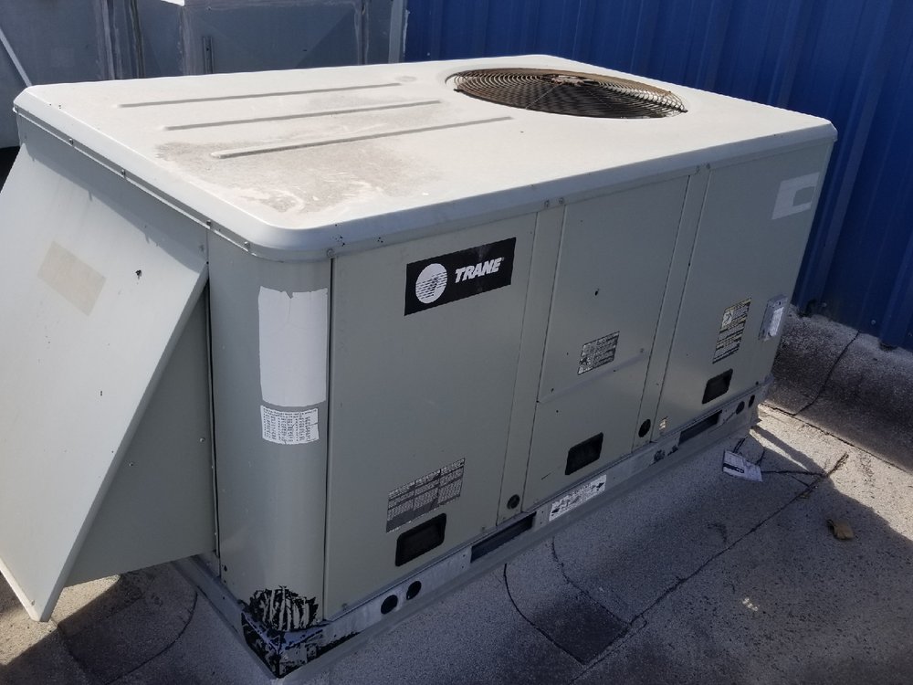 Electro Cooling Service technicians installing and servicing a Trane rooftop package HVAC unit on a commercial building in the Rio Grande Valley